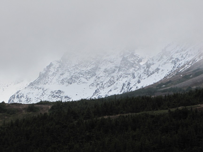 Mysterious mountains cloaked in translucent clouds